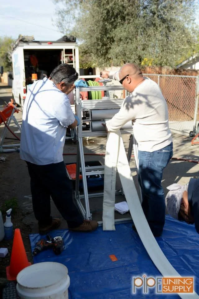 Technicians assembling HVAC unit with metal shelving and ductwork components in service yard