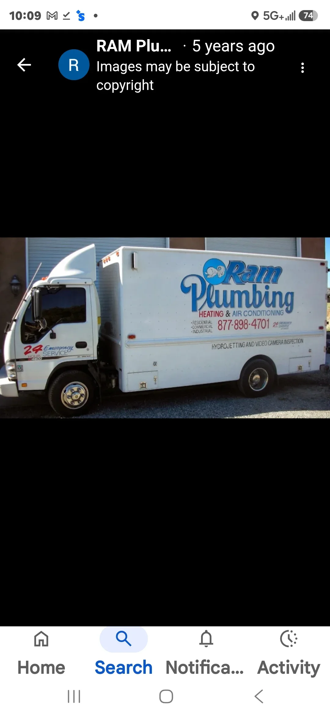 White RAM Plumbing service truck with blue branding and contact number 877-898-4701